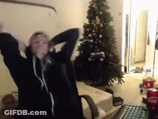 Person Standing In Front Of Christmas Tree GIF