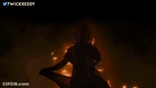 Person Standing In Front Of Fire With Twitter Username 7Wickreddy GIF