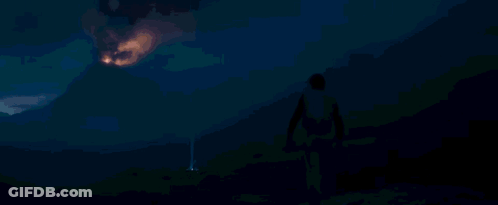 Person Standing In Front Of Large Fireball GIF