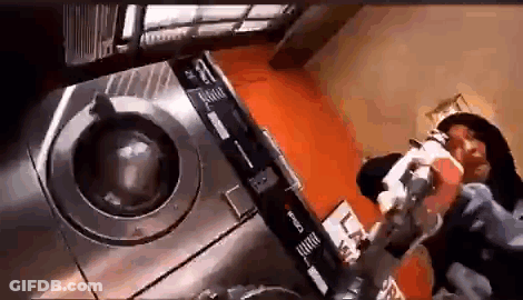 Person Standing In Front Of Laundromat Machine GIF