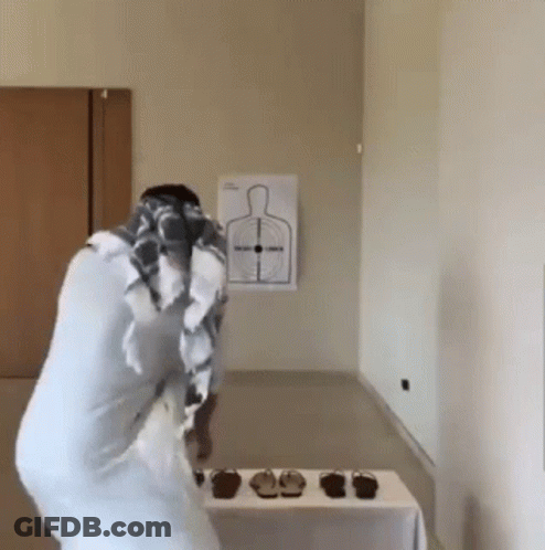 Person Standing In Front Of Person-Shaped Target GIF