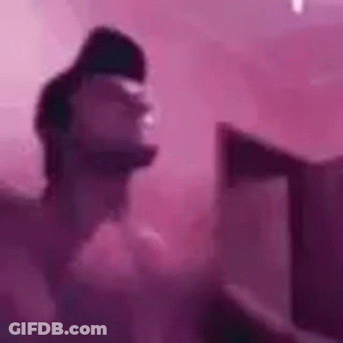 Person Standing In Front Of Pink Wall GIF