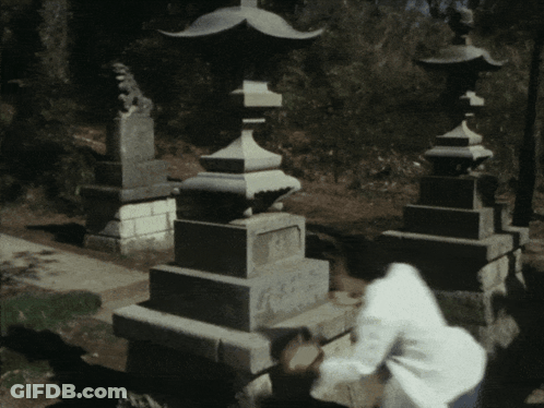 Person Standing In Front Of Statue That Says A GIF