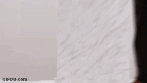 Person Standing In Front Of White Wall GIF