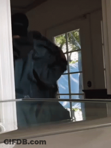 Person Standing In Front Of Window With Blue Tarp GIF
