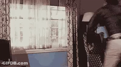 Person Standing In Front Of Window With Laptop GIF