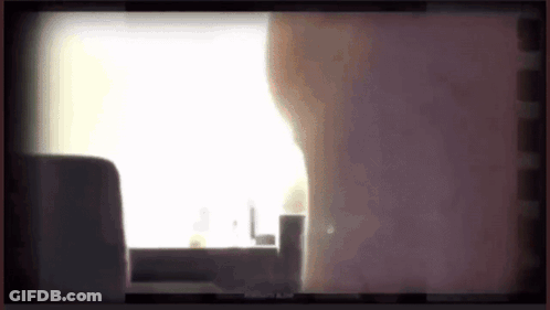 Person Standing In Front Of Window With Purple Background GIF