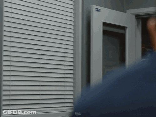 Person Standing In Front Of Window With R82 Sign GIF