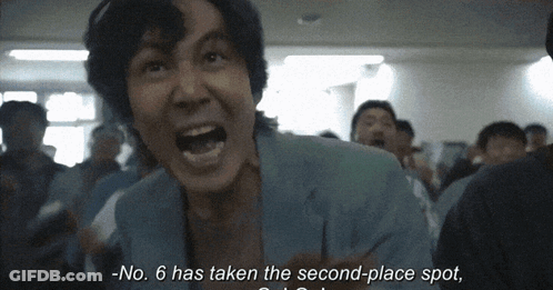 Person Standing In Hallway With Exit Sign GIF
