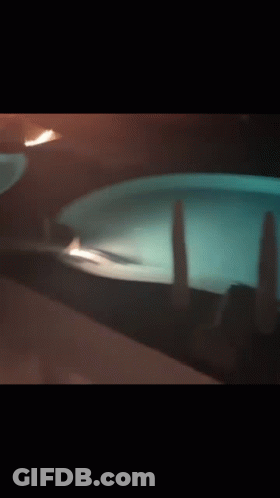Person Standing In Pool At Night GIF