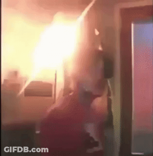 Person Standing In Room With Fire Ceiling GIF