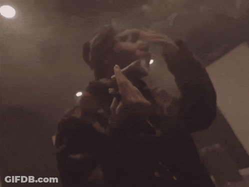Person Standing In Room With Smoke Coming Out GIF
