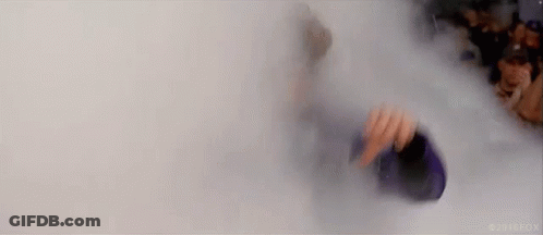 Person Standing In Smoke-Filled Room Holding Bottle GIF