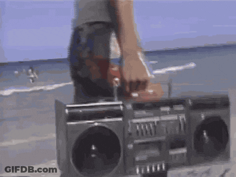 Person Standing Next To Boombox On Beach GIF