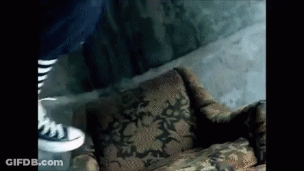 Person Standing Next To Patterned Chair GIF