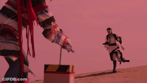 Person Standing Next To Yellow And Black Striped Box GIF