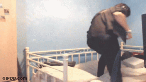 Person Standing On Bed In Blue Room GIF