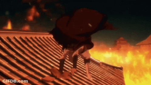 Person Standing On Roof With Flames Behind GIF