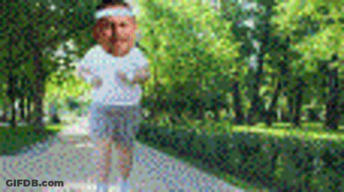 Person Standing On Sidewalk In Park GIF