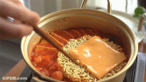 Person Stirring Pot Of Noodles With Cheese GIF