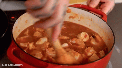 Person Stirring Pot Of Shrimp Stew With Wooden Spoon GIF