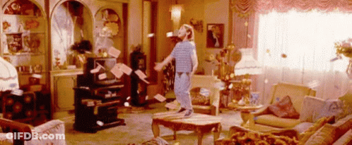 Person Surrounded By Flying Papers GIF