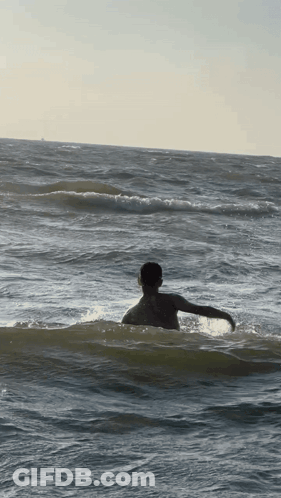 Person Swimming In Ocean With Arms Outstretched GIF