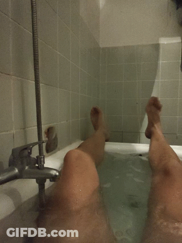 Person Taking Bath With Feet In Water GIF