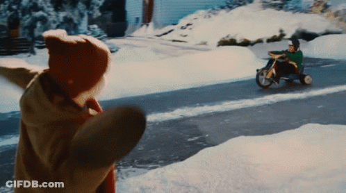 Person Throwing Snow At Tricycle Rider GIF