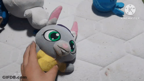 Person Touching Stuffed Animal With Yellow Shirt GIF