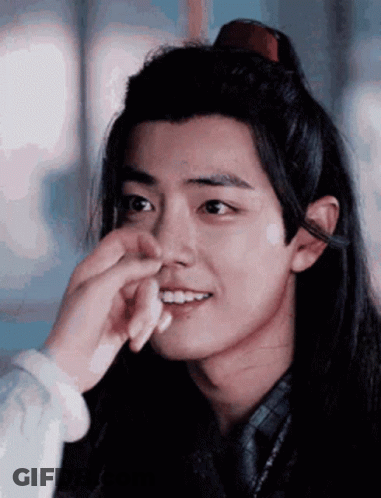 Person Touching Young Man's Face GIF