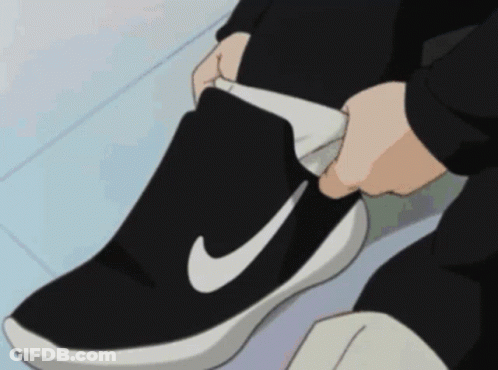 Person Tying Shoe With White Nike Logo GIF