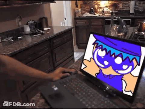 Person Typing On Laptop With Cartoon Character GIF