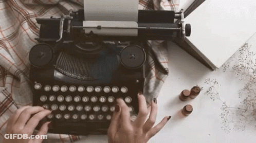 Person Typing On Old Typewriter With A B GIF