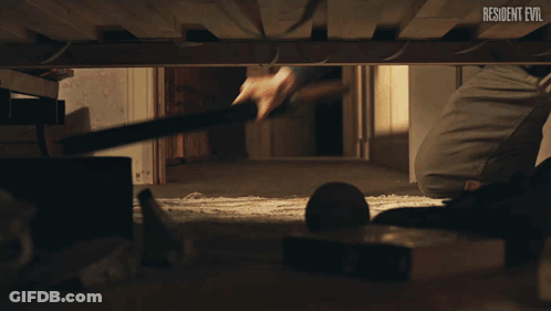 Person Under Bed With Resident Evil GIF