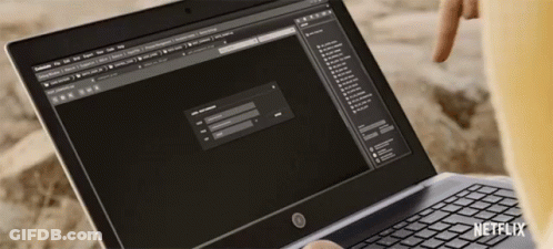 Person Using Laptop With Netflix Logo GIF
