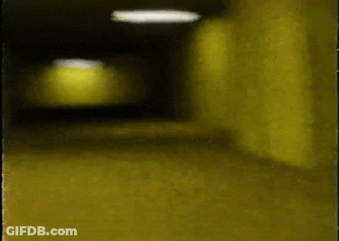 Person Walking Down Dark Hallway GIF