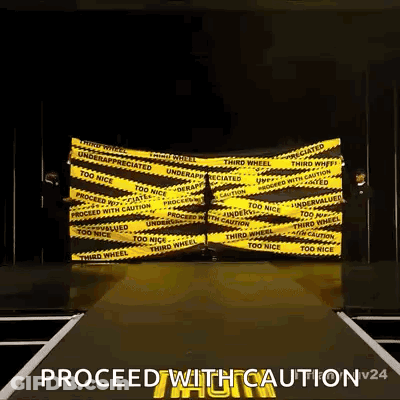 Person Walking Down Runway With Yellow Caution Tape GIF