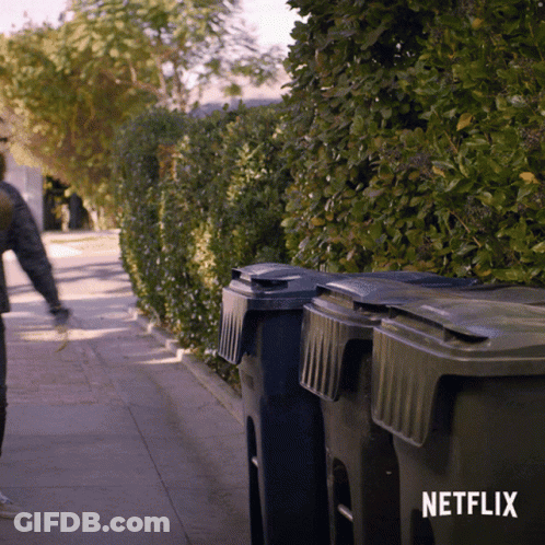 Person Walking Down Sidewalk With Netflix Logo GIF