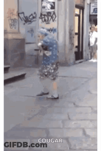 Person Walking Down Sidewalk With Word Cougar GIF