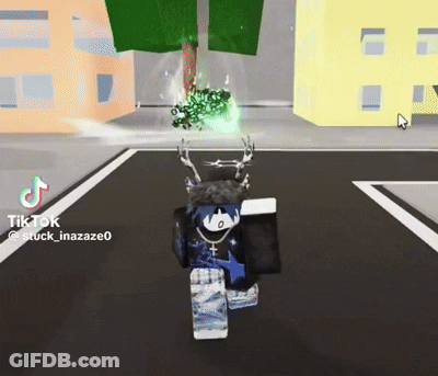 Person Walking Down Street With Tree GIF