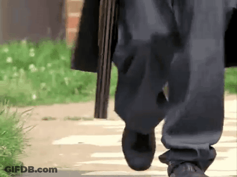Person Walking Holding Shotgun GIF
