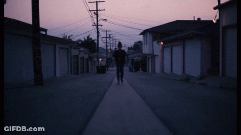 Person Walking On Street With Purple Sky GIF