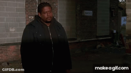 Person Walking Past Brick Building With Parking Sign GIF