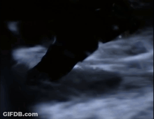 Person Walking Through Dark Room With Smoke GIF