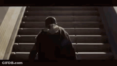 Person Walking Up Stairs With Hat GIF