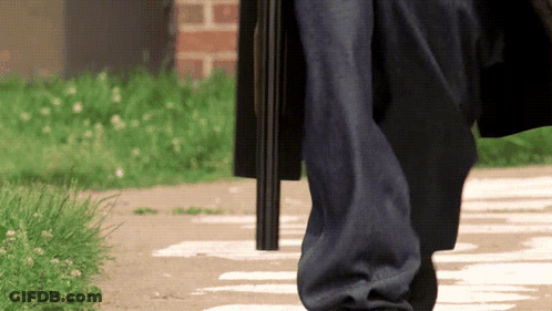Person Walking With Gun In Pocket GIF