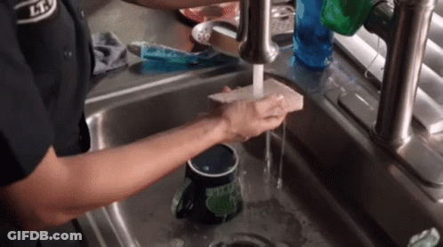Person Washing Mug In Kitchen Sink GIF