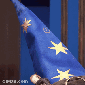 Person Wearing Blue Wizard Hat With Gold Stars GIF