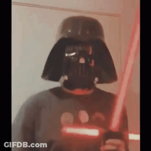 Person Wearing Darth Vader Mask Holding Lightsaber GIF